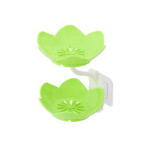 Flower-shaped soap dish, self-draining for use in bathroom, kitchen, or bathtub.