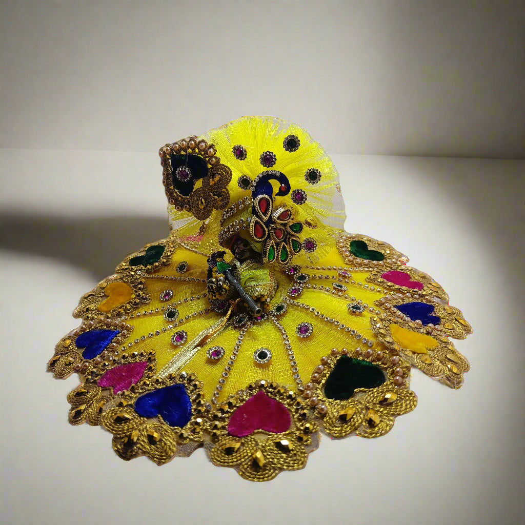 Decorative yellow laddu gopal ji dress with peacock design on a white background