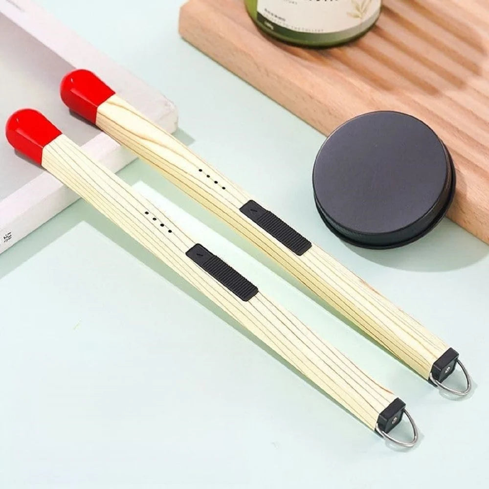 Electric matchstick lighter held in hand showing wood grain texture body red safety cap arc prongs battery LED indicator and metal keyring loop