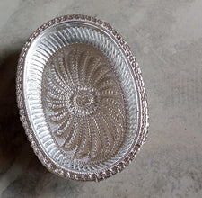 Multipurpose oval silver tray with a royal pattern for various uses.