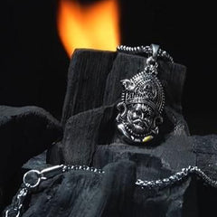 Shri Khatu Shyam Ji Maharaj Pendant with Chain resting on charcoal with a flame in the background.