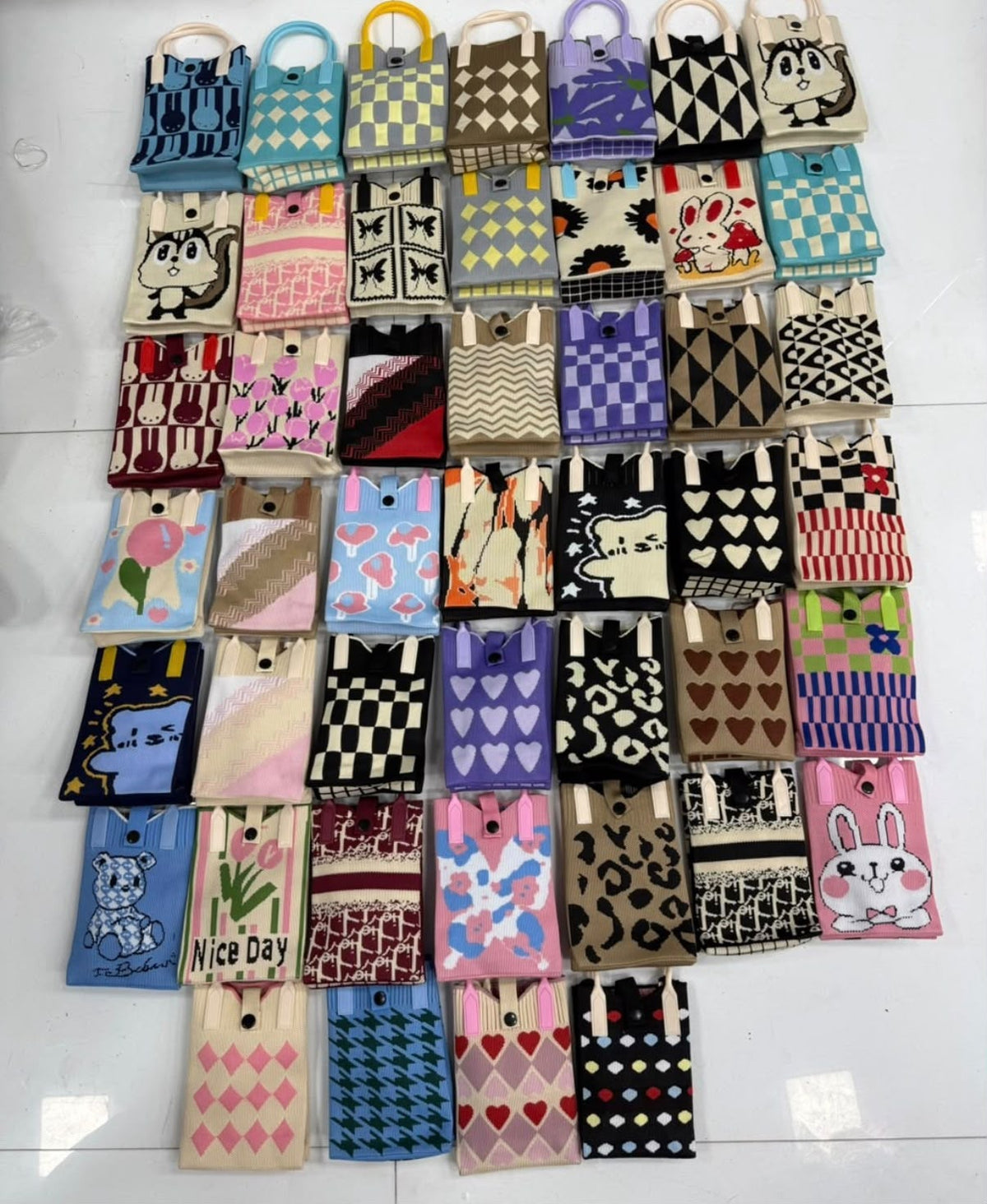 Supplier assortment of mini bags in cartoon, checkerboard, floral and heart designs