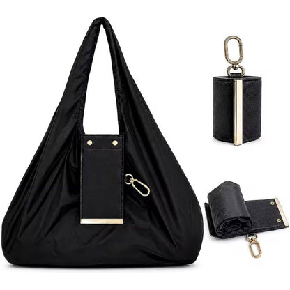 Foldable keychain tote bag in black with PU leather compact pouch and gold carabiner clip unfolded view