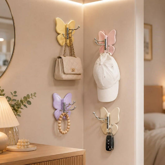 Butterfly wall hooks in all 4 colors mounted on wall with bags keys and accessories hanging lifestyle shot