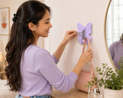 Woman hanging bag on lavender purple rotating butterfly wall hook in bedroom vanity setup lifestyle photo
