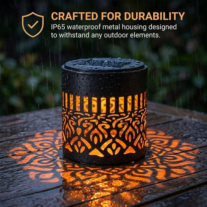 Solar mandala light crafted for durability IP65 waterproof metal housing glowing orange in rain on wooden outdoor table